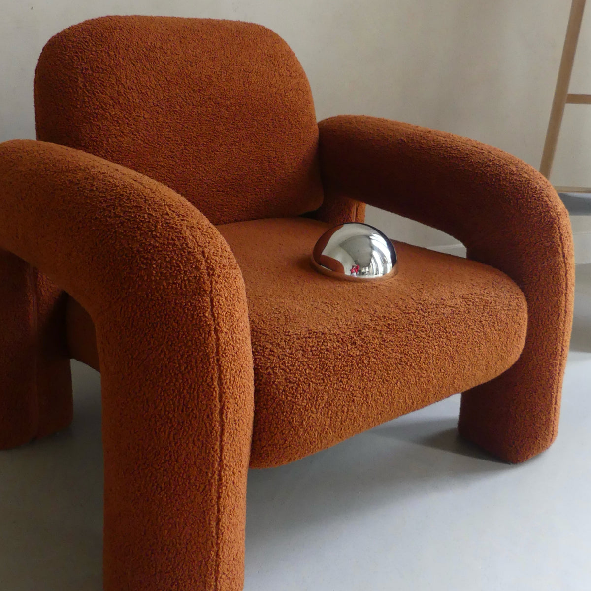 Lumevre convex mirror 15 cm resting on a chair seat to show its size