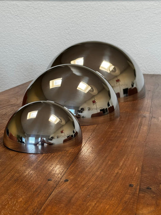 Three convex mirrors lined up in a living room, ready to be used as an interior object