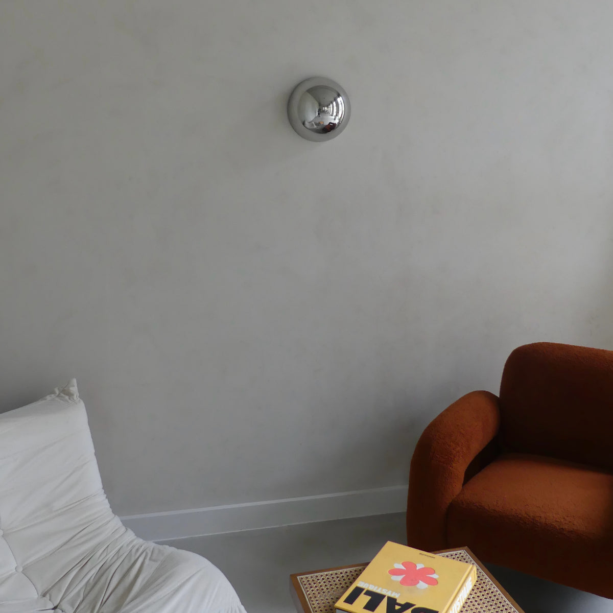 The Lumevre convex mirror 25 cm mounted on a wall seen from a distance
