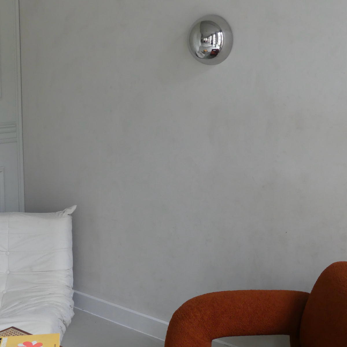 A side view of the Lumevre convex mirror 25 cm mounted on a wall