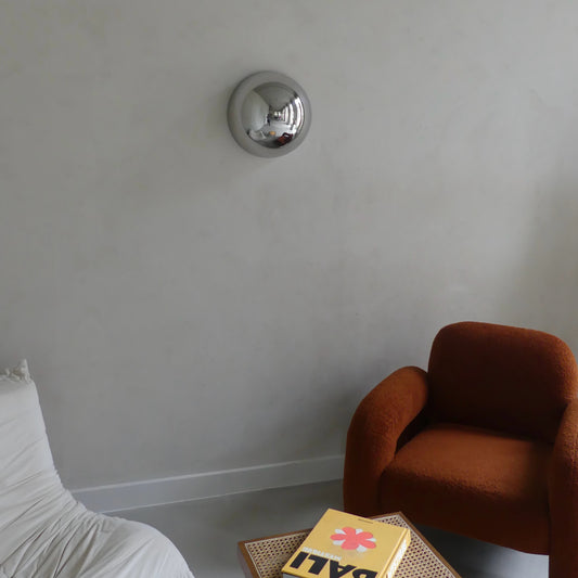 The Lumevre convex mirror 35 cm mounted on a wall seen from a distance