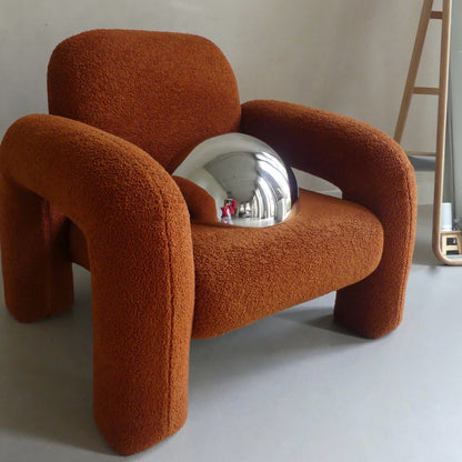 The Lumevre convex mirror 35 cm resting on a chair seat to show its size