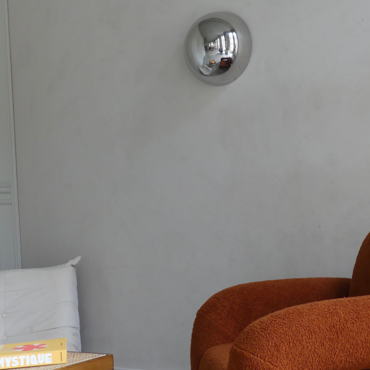 A side view of the Lumevre convex mirror 35 cm mounted on a wall